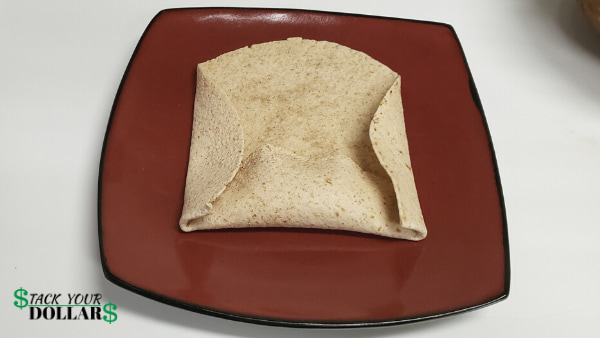 Folding the sides of a burrito to wrap